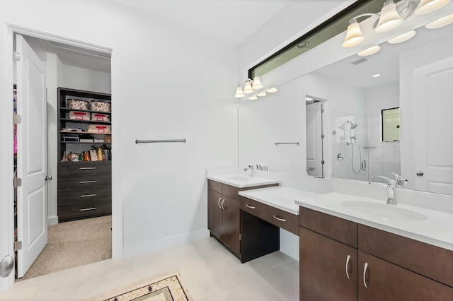 bathroom featuring visible vents, a stall shower, two vanities, and a sink