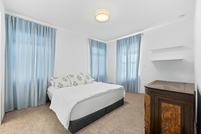 bedroom featuring light colored carpet