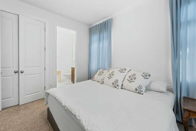 bedroom with ensuite bath and a closet