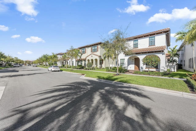 view of street featuring a residential view, curbs, and sidewalks