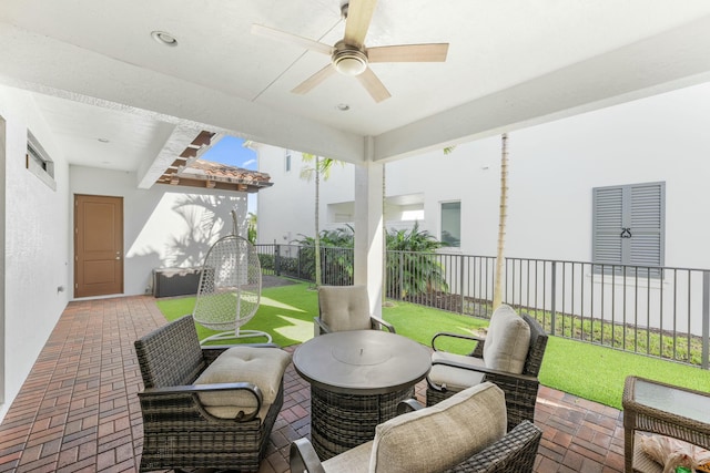 view of patio featuring fence and ceiling fan