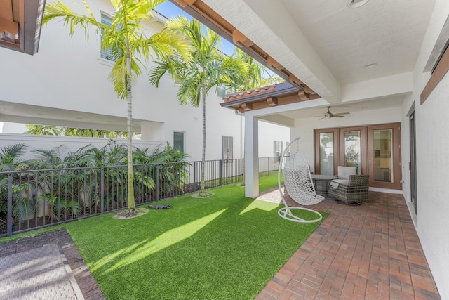 view of yard featuring a patio, a ceiling fan, and a fenced backyard