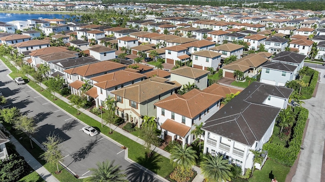 drone / aerial view with a residential view and a water view