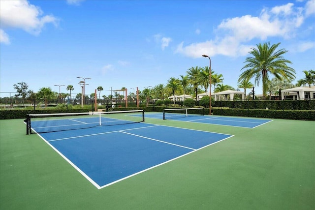 view of tennis court featuring fence