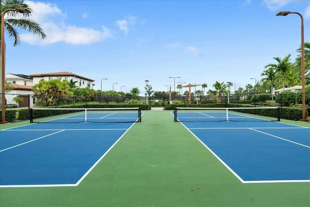 view of tennis court featuring fence