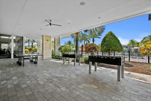 view of patio with a ceiling fan and fence