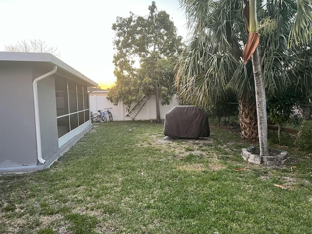 view of yard with a sunroom and fence