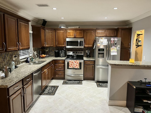 kitchen with light stone counters, crown molding, stainless steel appliances, visible vents, and a sink