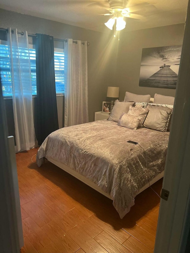 bedroom featuring wood finished floors and a ceiling fan