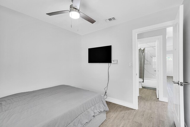 bedroom featuring light wood-style floors, baseboards, visible vents, and a ceiling fan