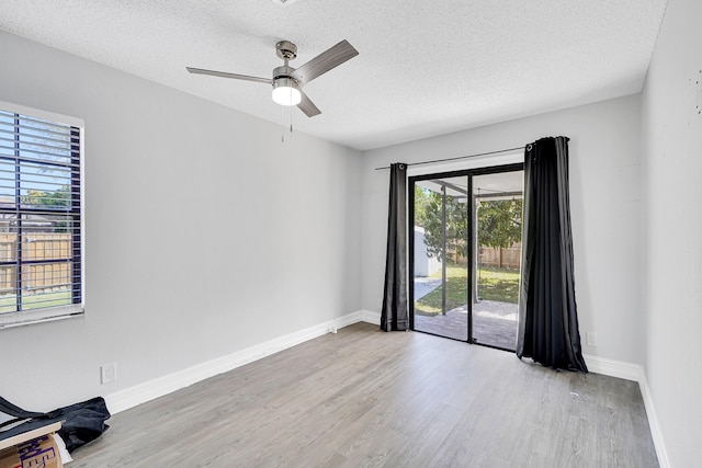 unfurnished room featuring a textured ceiling and wood finished floors