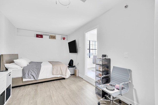 bedroom featuring light wood-style floors and baseboards