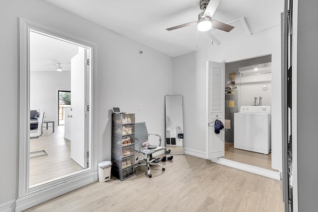 office featuring washer / clothes dryer, electric water heater, ceiling fan, wood finished floors, and baseboards