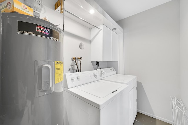 laundry room with water heater, washer and clothes dryer, cabinet space, and baseboards