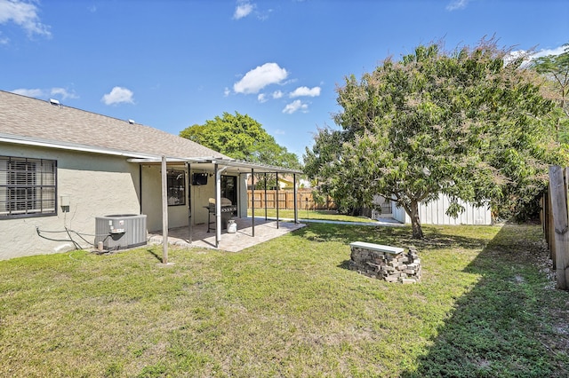 view of yard featuring a patio, central AC unit, and a fenced backyard