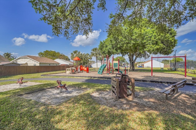 communal playground with a lawn and fence