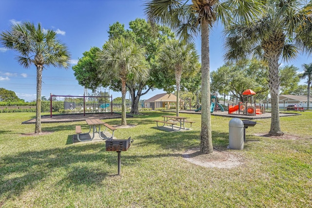 view of community featuring playground community and a yard