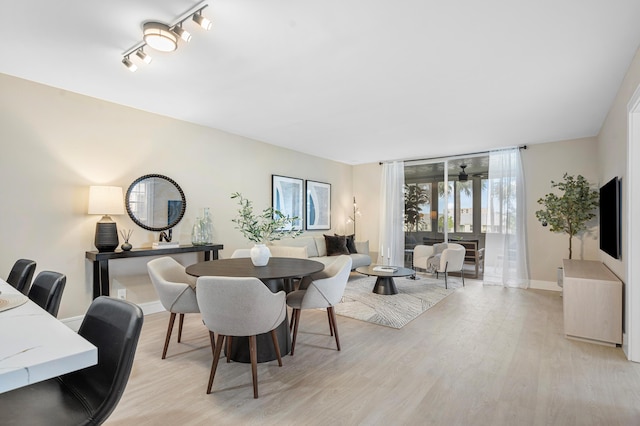 dining room with light wood-type flooring and baseboards