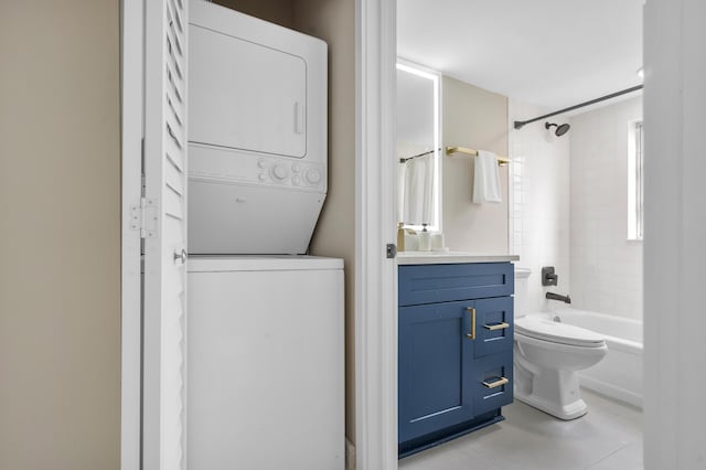 bathroom featuring shower / bathtub combination, tile patterned flooring, toilet, stacked washer and dryer, and vanity