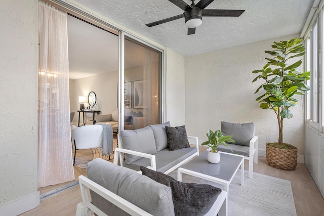 sunroom with plenty of natural light and ceiling fan