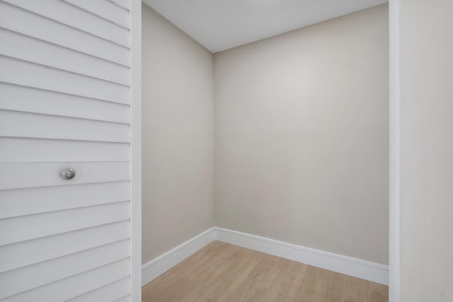 empty room with light wood finished floors and baseboards