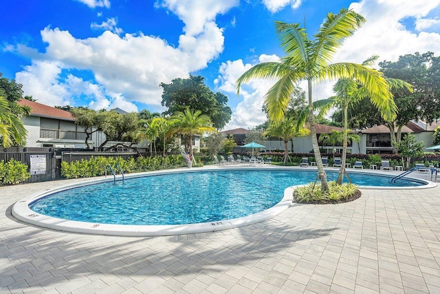 pool featuring fence and a patio