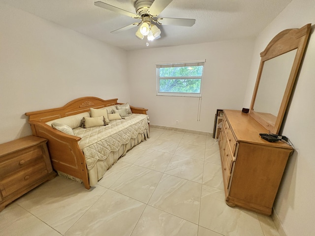 bedroom with ceiling fan and baseboards