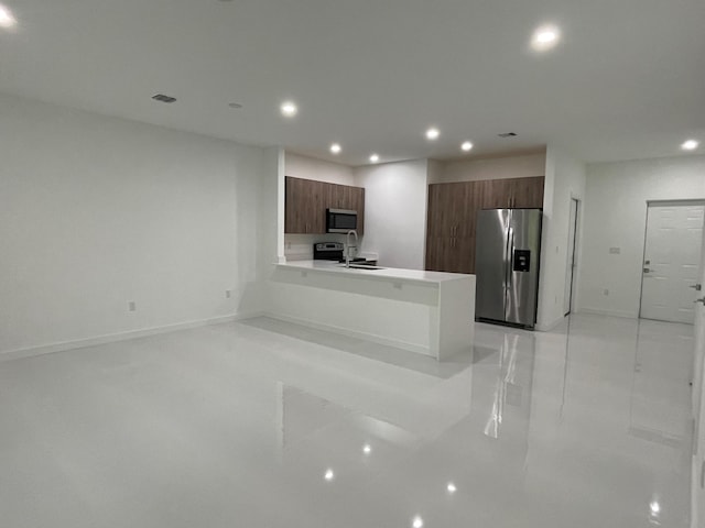 kitchen featuring light countertops, recessed lighting, a peninsula, stainless steel appliances, and modern cabinets