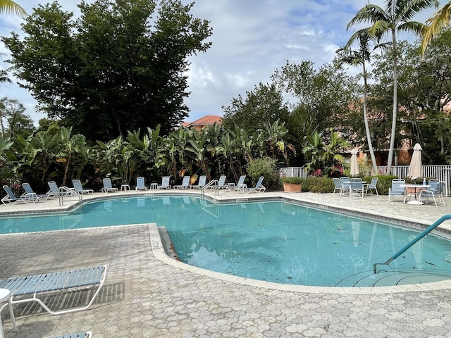 pool featuring a patio and fence