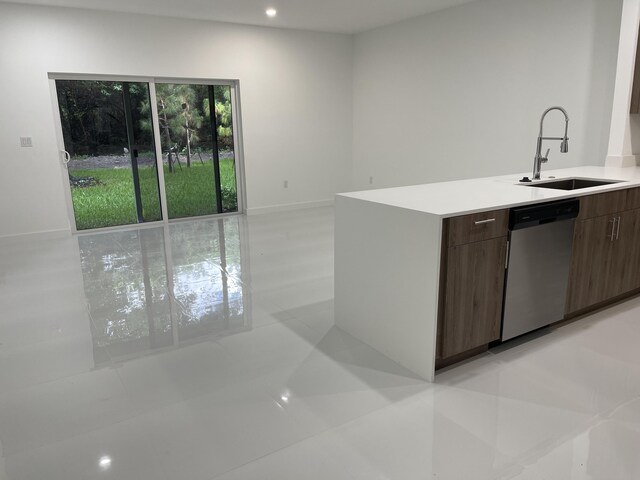 kitchen with recessed lighting, a sink, light countertops, dishwasher, and modern cabinets