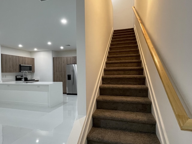 staircase featuring recessed lighting