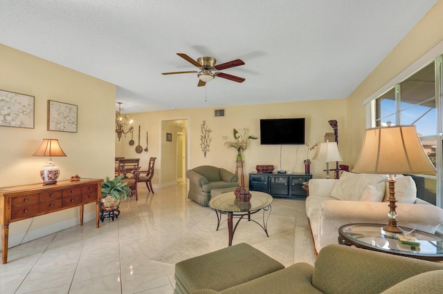 living room with visible vents and ceiling fan with notable chandelier