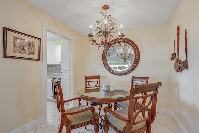 dining area with light tile patterned floors, baseboards, and an inviting chandelier