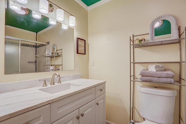 bathroom with a shower, crown molding, vanity, and toilet