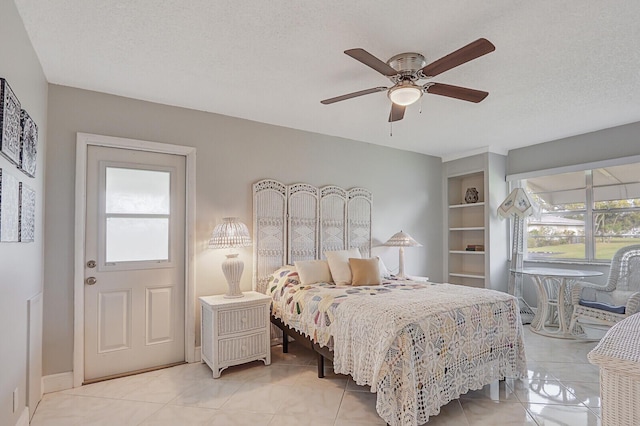 bedroom with multiple windows, ceiling fan, a textured ceiling, and light tile patterned flooring