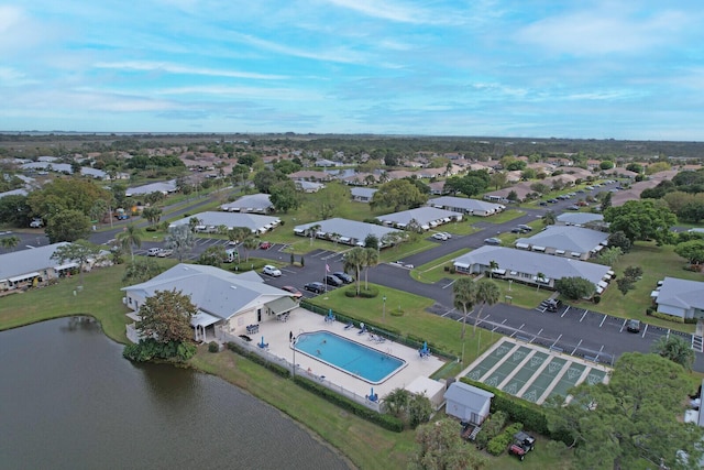 drone / aerial view featuring a residential view and a water view