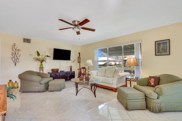 living room featuring a ceiling fan, visible vents, and light tile patterned floors