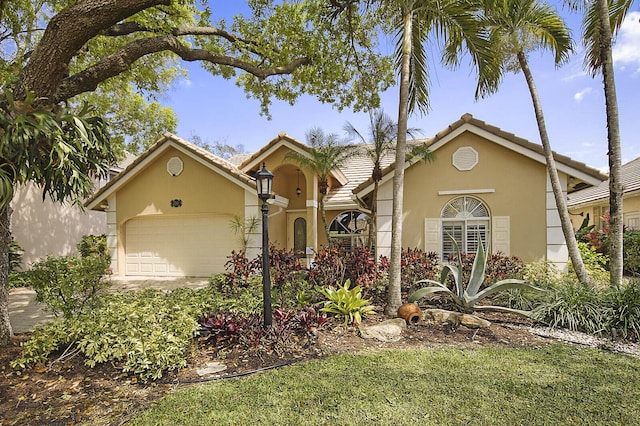 2045 NW 127th Ter, Coral Springs, FL 33071 - mediterranean / spanish house featuring a tiled roof, a garage, and stucco siding