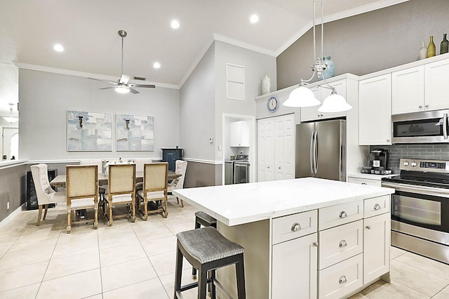 2045 NW 127th Ter, Coral Springs, FL 33071 - kitchen with ornamental molding, ceiling fan, a center island, and appliances with stainless steel finishes