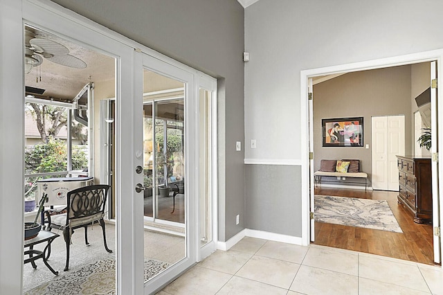 2045 NW 127th Ter, Coral Springs, FL 33071 - doorway with light tile patterned flooring, ceiling fan, and baseboards
