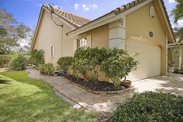 2045 NW 127th Ter, Coral Springs, FL 33071 - view of home's exterior with stucco siding, driveway, a tiled roof, and a yard