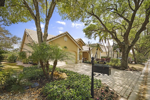 2045 NW 127th Ter, Coral Springs, FL 33071 - view of front of house featuring stucco siding, a tile roof, concrete driveway, and an attached garage