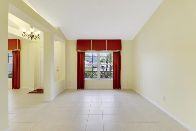 empty room featuring lofted ceiling, an inviting chandelier, baseboards, and light tile patterned flooring