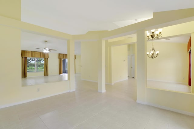 unfurnished room with ceiling fan with notable chandelier, light tile patterned floors, and baseboards