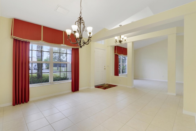 empty room featuring lofted ceiling, a notable chandelier, baseboards, and light tile patterned floors