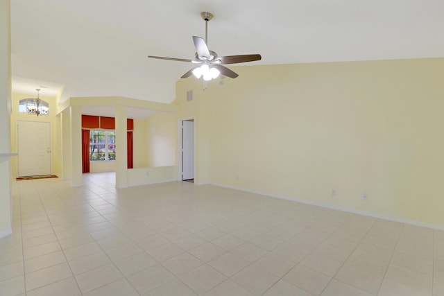 unfurnished room featuring light tile patterned floors, visible vents, baseboards, high vaulted ceiling, and ceiling fan with notable chandelier