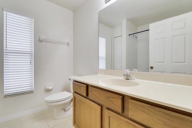 bathroom featuring baseboards, vanity, toilet, and tile patterned floors