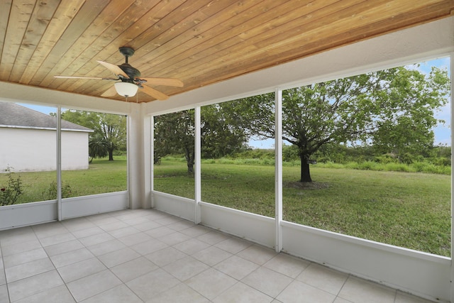 unfurnished sunroom with ceiling fan and wooden ceiling