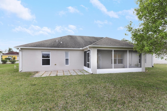 back of property featuring a lawn, a patio area, a sunroom, and stucco siding