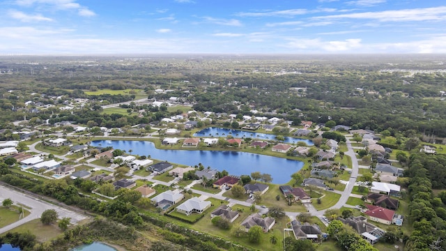 drone / aerial view with a water view and a residential view